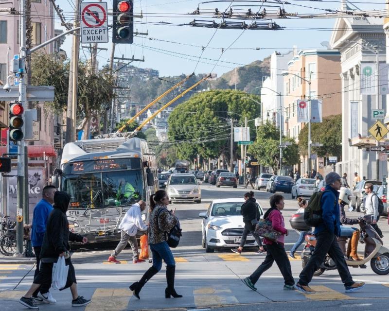 Pedestrians crossing the intersection at 16th and Mission streets.