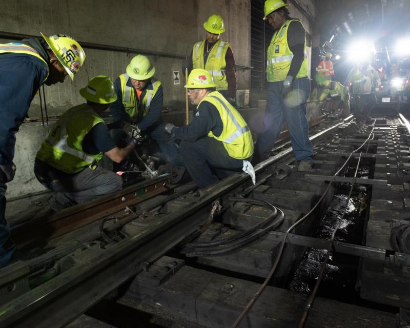 Track Department team drilling holes in new rail for Embarcadero Crossover during Fix It! Week, April 21, 2022.