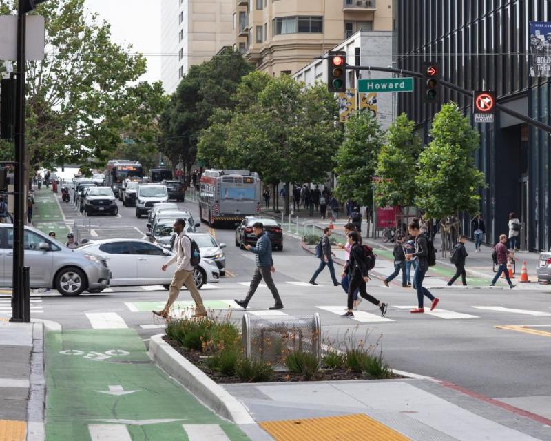 People walking across 2nd Street