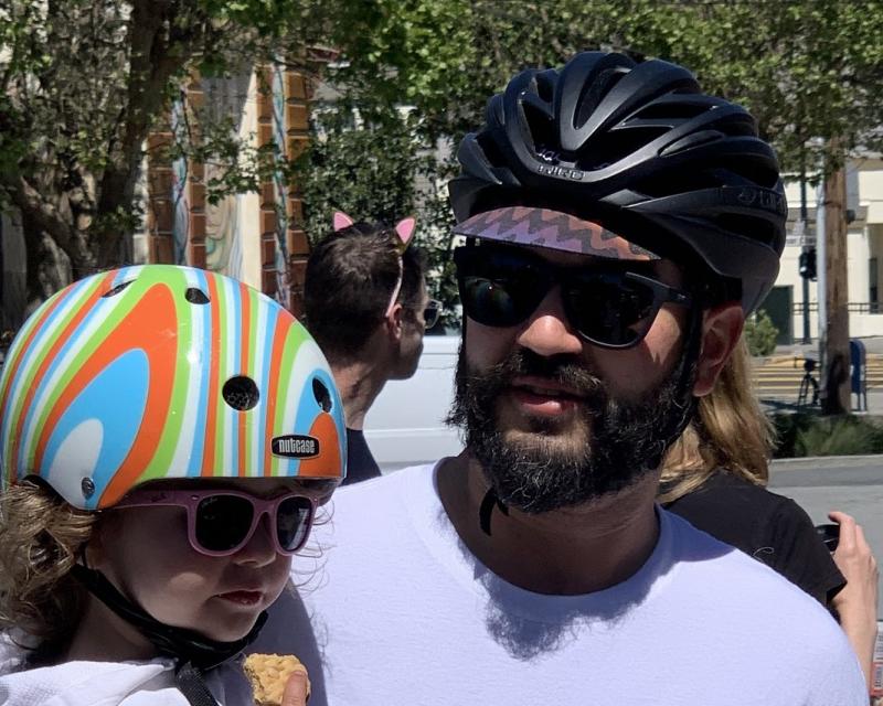 Father and daughter wearing bike helmets