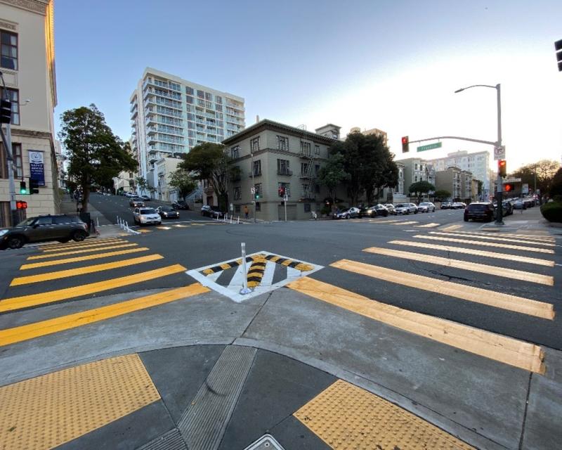 A crosswalk in San Francisco with upgraded safety installations.