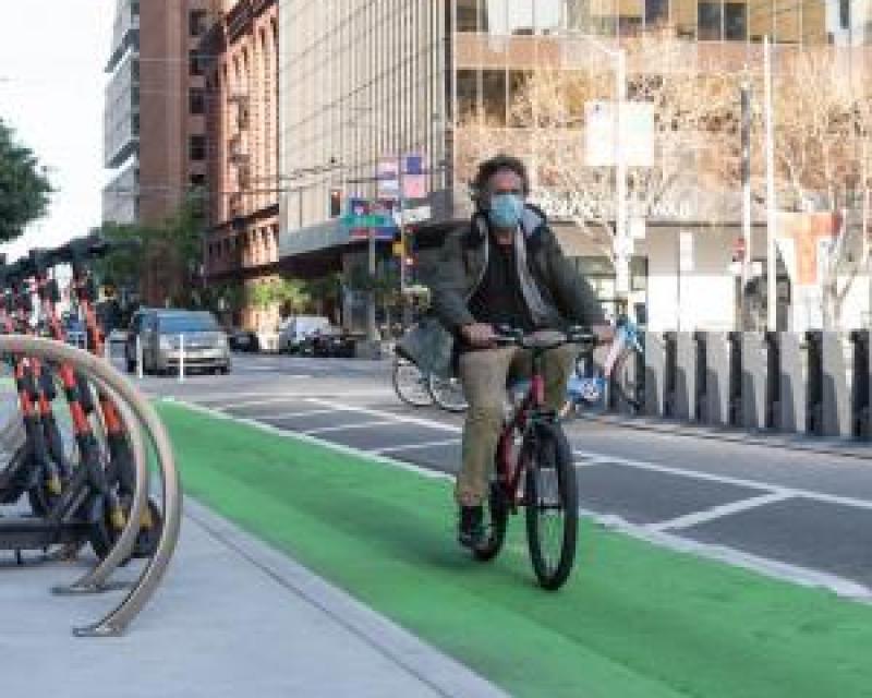 person biking in a protected bikeway on Howard Street