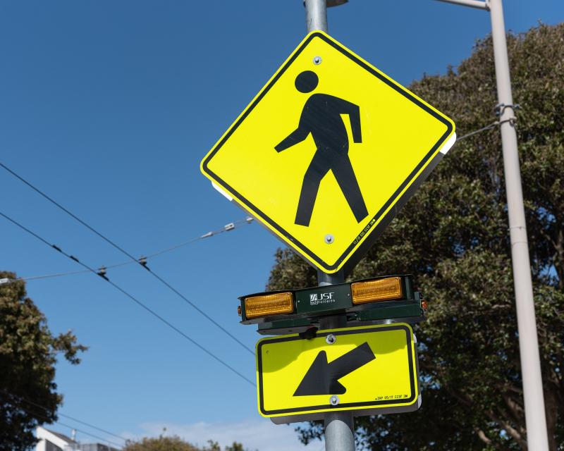 Pedestrian activated flashing beacon with pedestrian warning sign