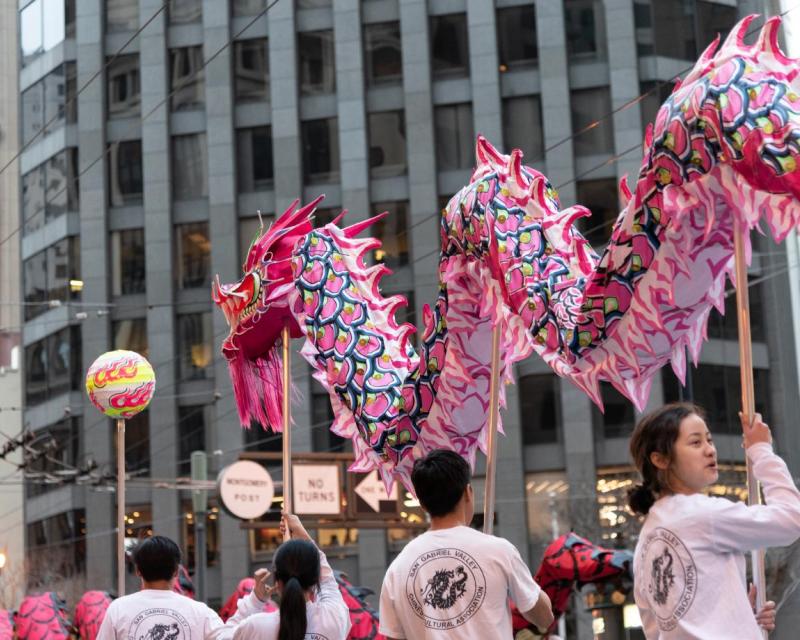Parade-goers carry a Chinese dragon down a San Francisco street