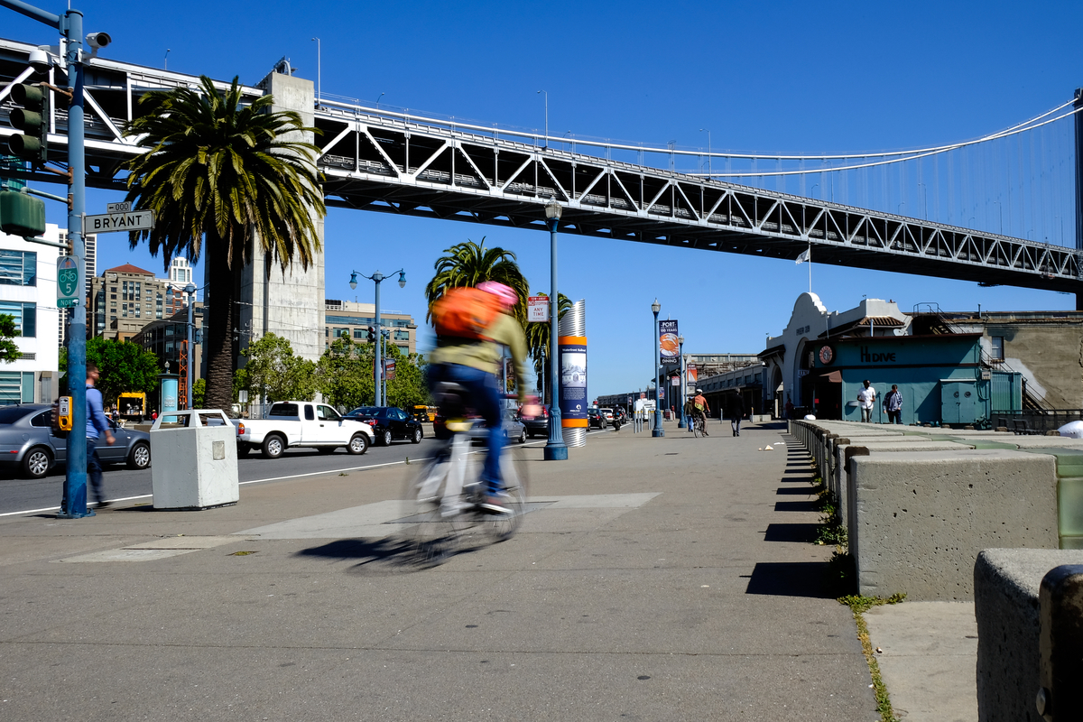 Bicyclist out for a ride along The Embarcadero on a sunny afternoon.