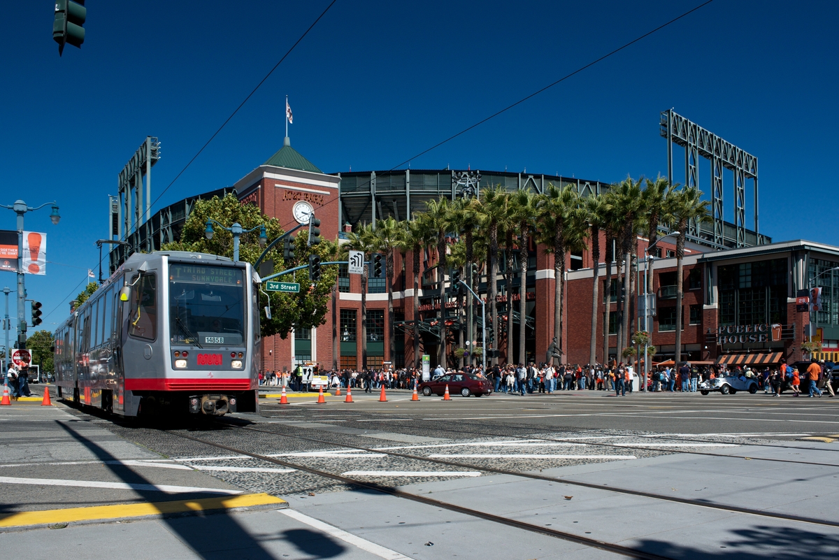 Southbound T Third train rolling by AT&T Park during an afternoon baseball game.