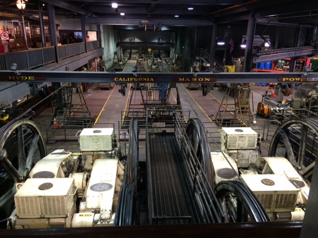 A view of the cable car gearboxes next to motor wheels and cables in the Cable Car Barn and Powerhouse.