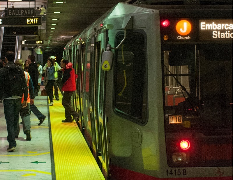 People disembark from a J Church Muni Metro train at Embarcadero Station.