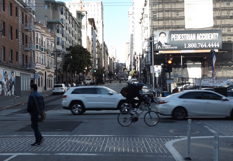 People walking, biking and driving across Taylor Street at Eddy Street.