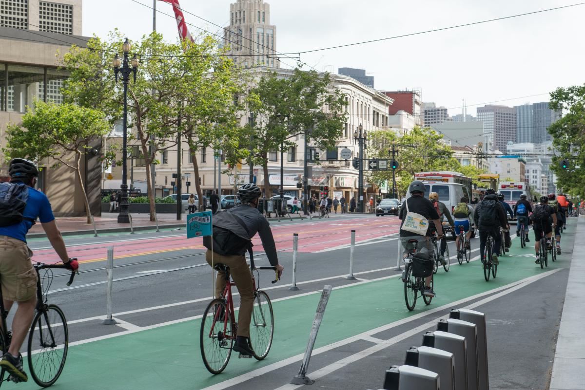 People biking eastbound down Market St.