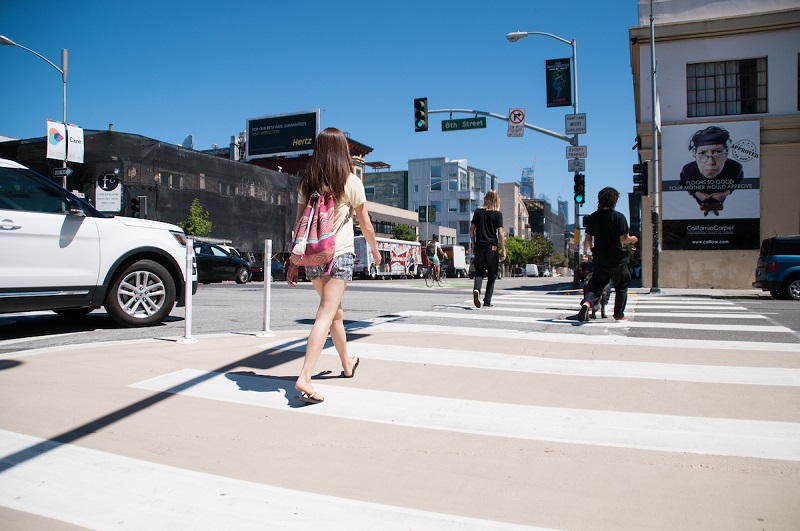 People using the crosswalk during the afternoon