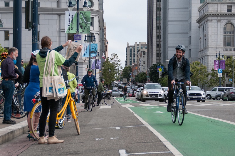 Bicyclist in bike lane by city hall