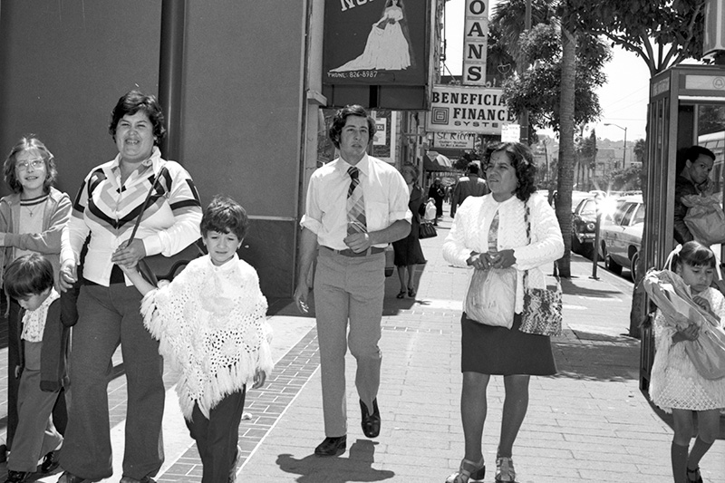 family walking on sidewalk