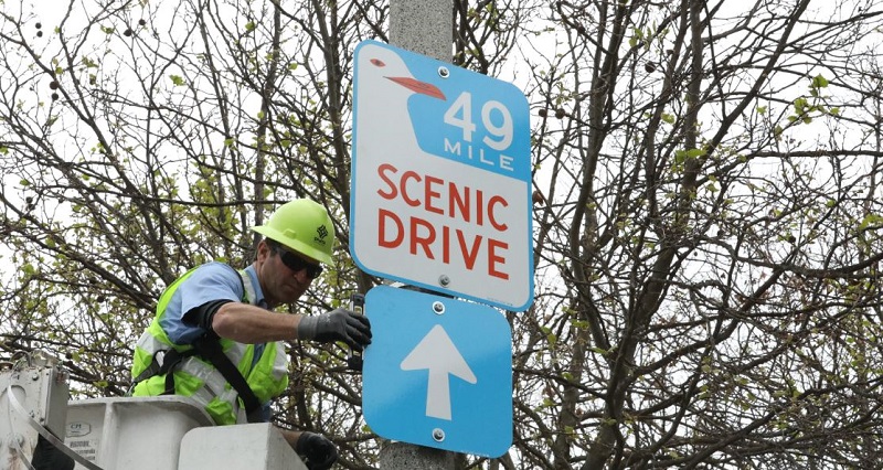 A Scenic Drive 49 sign going up.