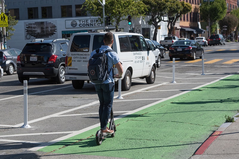 Person Riding Rental Scooter on Folsom Street