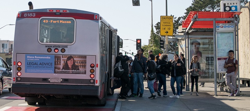 People boarding a 43 Fort Mason coach at Balboa Park.