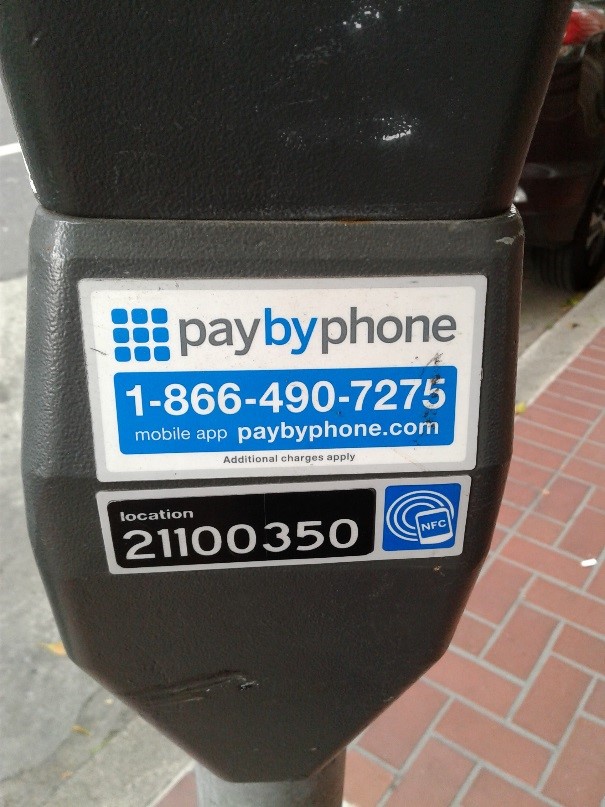 Photo of a parking meter with the pay by phone logo, phone number, and meter location number