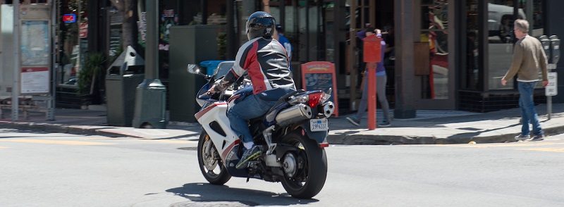 Motorcycle driving through intersection.