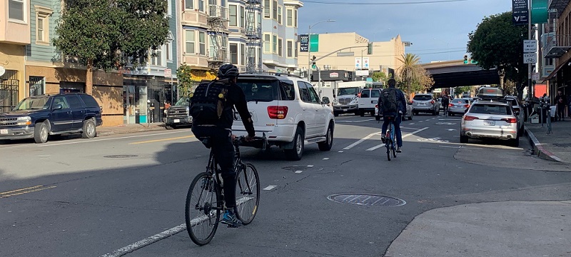 People biking along Valencia.