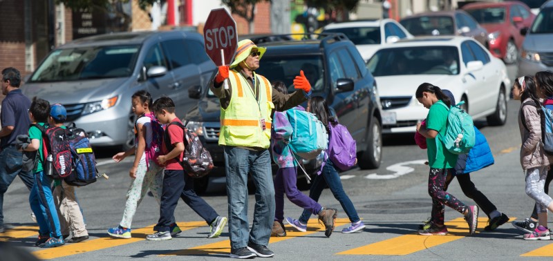 Kids crossing the street with crossing guard