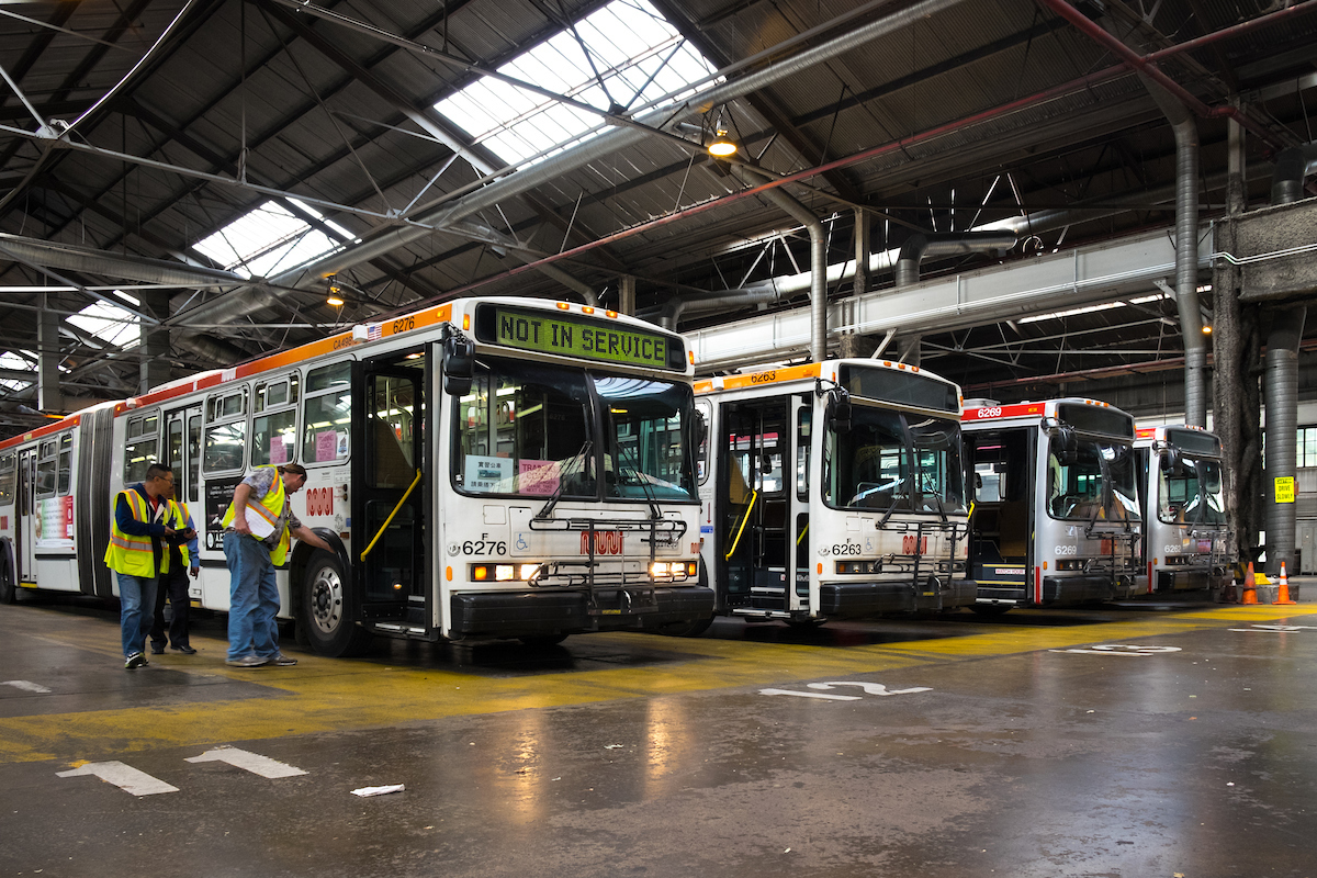 row of buses inside garage