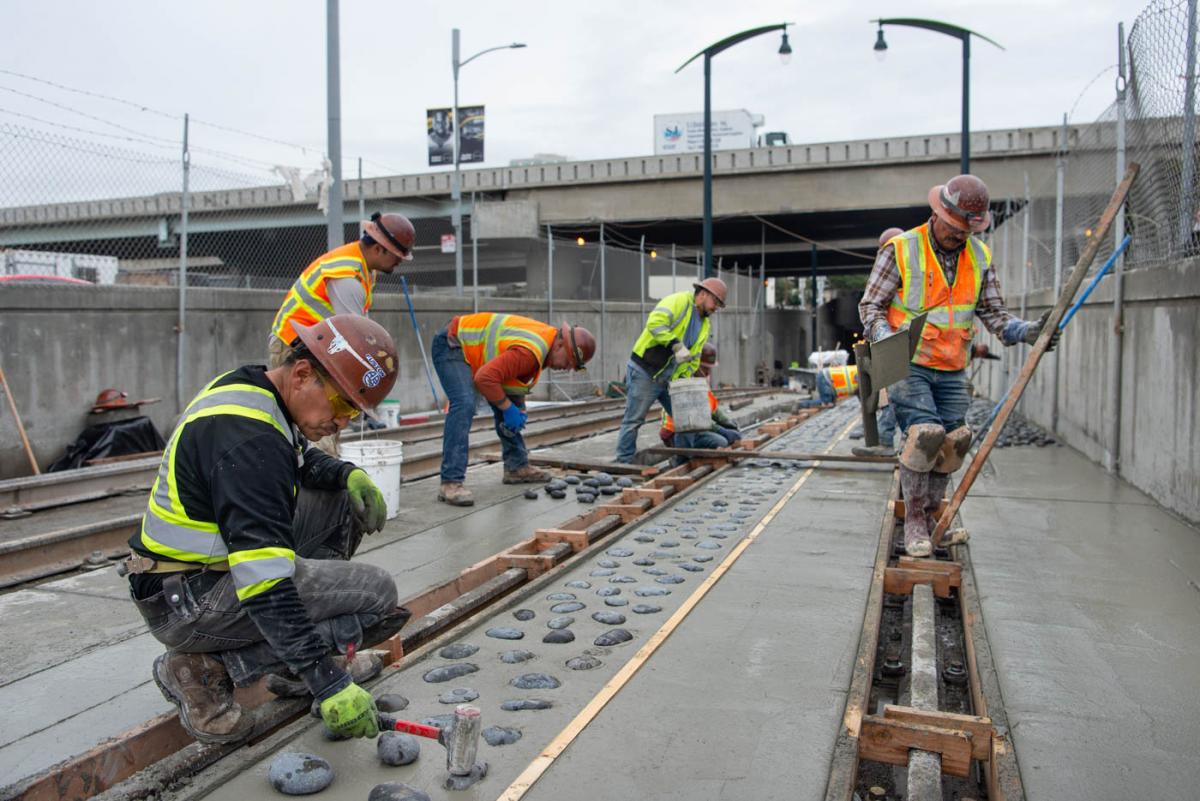 Large river rocks are placed into wet concrete to deter errant motorists from entering the tunnel portal.