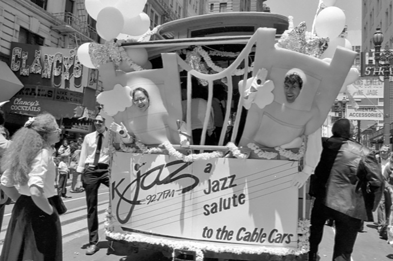 photo of people wearing costumes on back of cable car