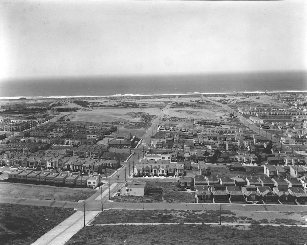 wide-angle view of outer sunset neighborhood with houses, sand dunes, and the pacific ocean