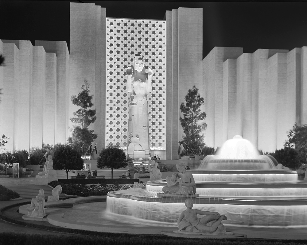 night view of statues, buildings, and fountains