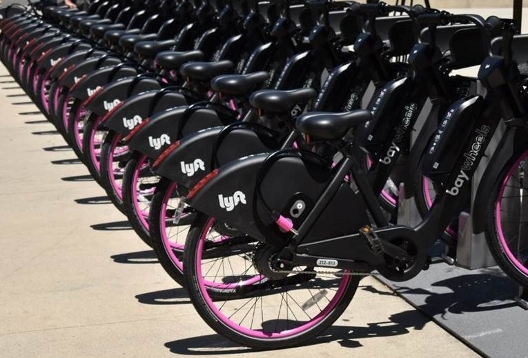 Row of black and pink Lyft bike share bikes