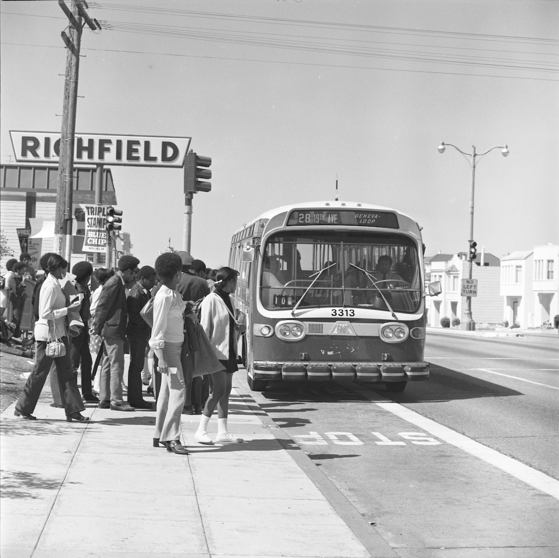 group of people waiting for approaching bus