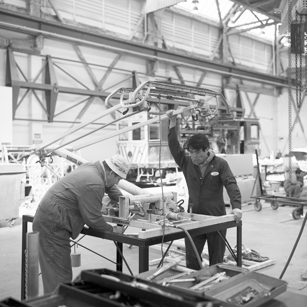 two people with pantograph inside repair shop