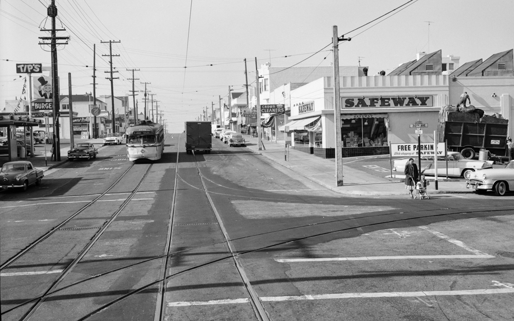 street view of Judah and 30th with people, streetcar, and storefronts