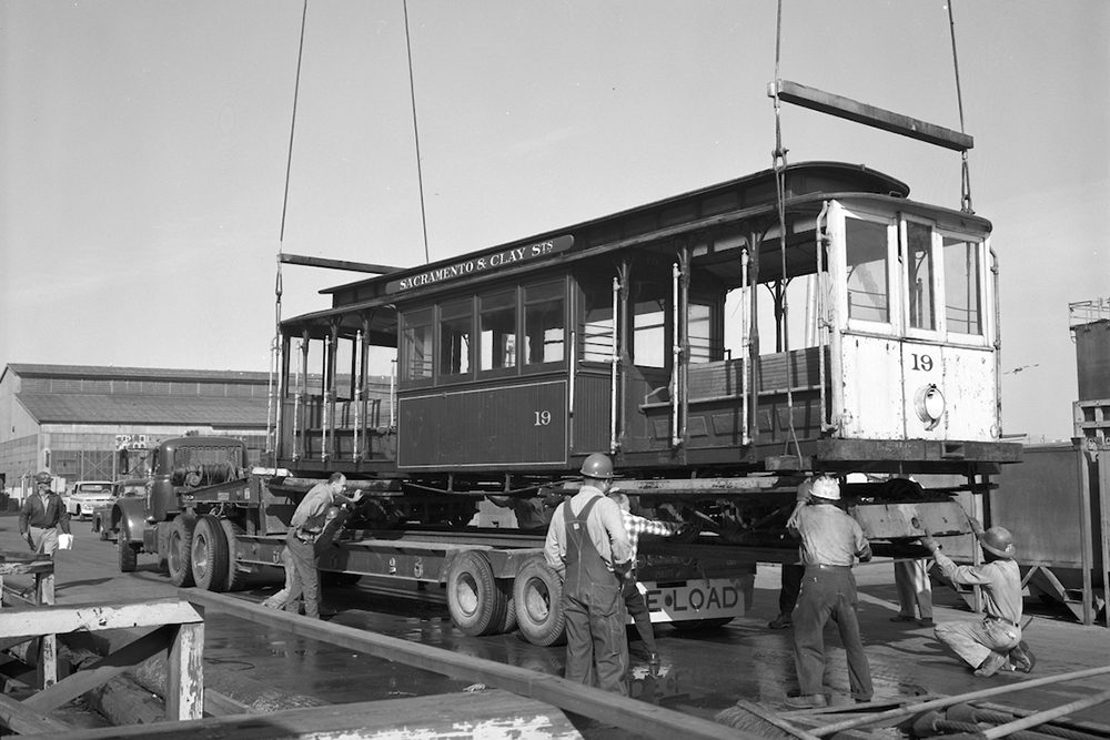 cable car 19 being loaded onto truck with crane
