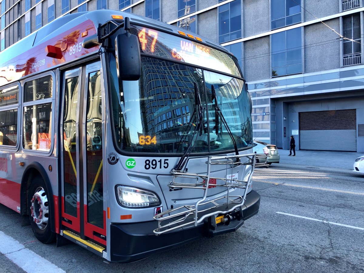 A Green Zone 47 Van Ness coach passing One South Van Ness