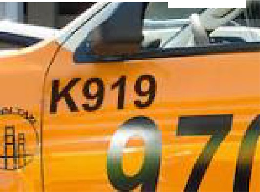 Taxi image with K in front of the Medallion number 919. 