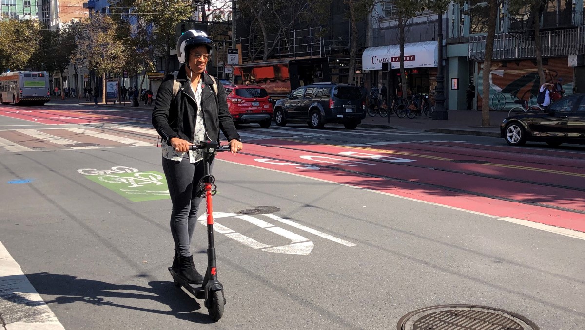 Lady on scooter with a helmet