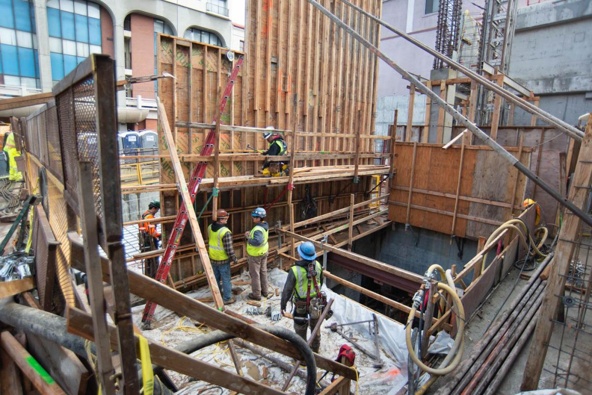 New concrete forms are going up to continue building the street level entrance for Chinatown - Rose Pak  Station.