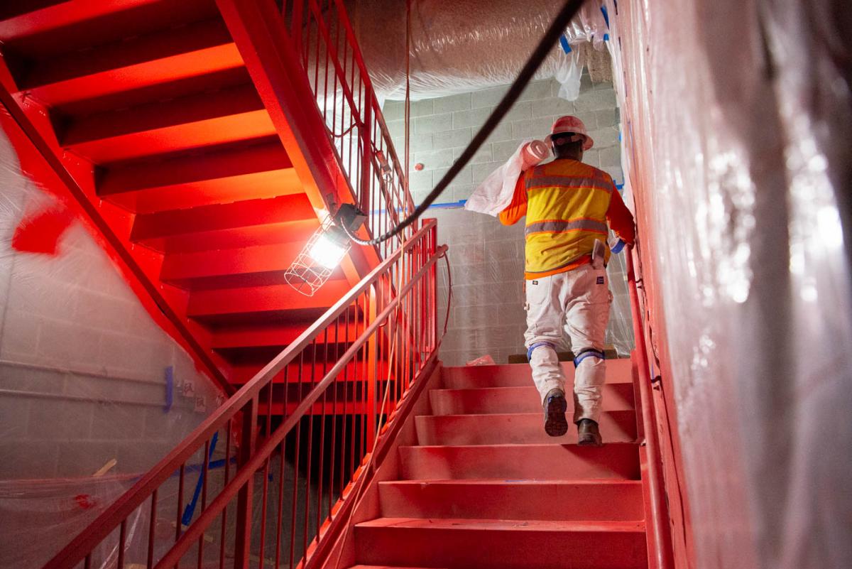 Emergency exit stairs at the north end of the station platform are being painted bright orange to aide in giving directions during an emergency.