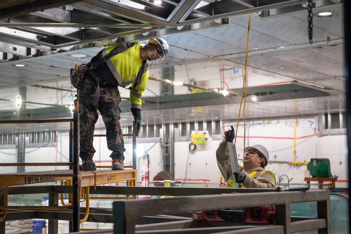 Pieces of steel framing are fabriated and installed piece by piece at the future fare gate entrance area.