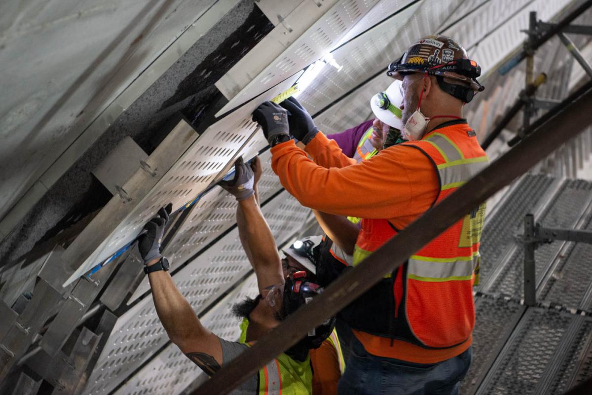 Perforated panels are installed as part of sound reduction and interior design elements inside the platform cavern.