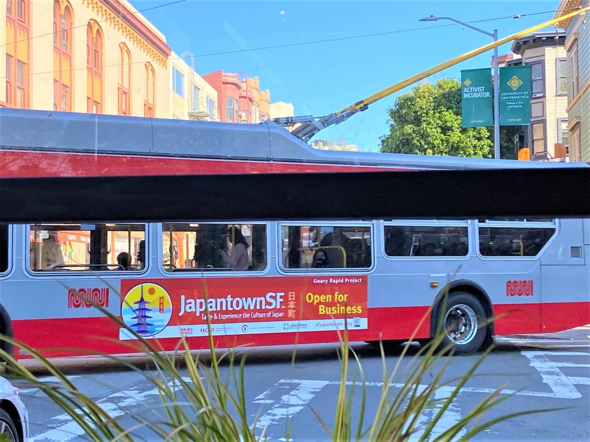 Photo of electric bus with banner advertising Japantown businesses