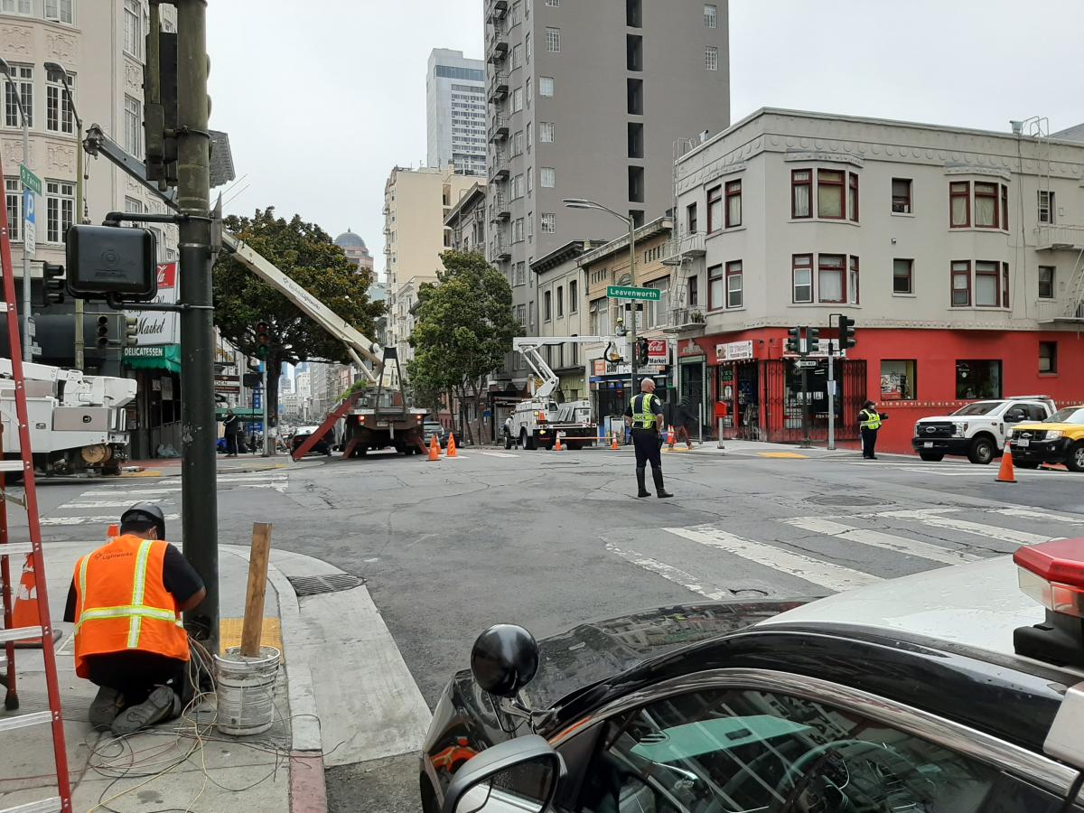 photo: Crews work on switching on the new traffic signal system, which now includes pedestrian countdown signals, at O’Farrell and Leavenworth streets