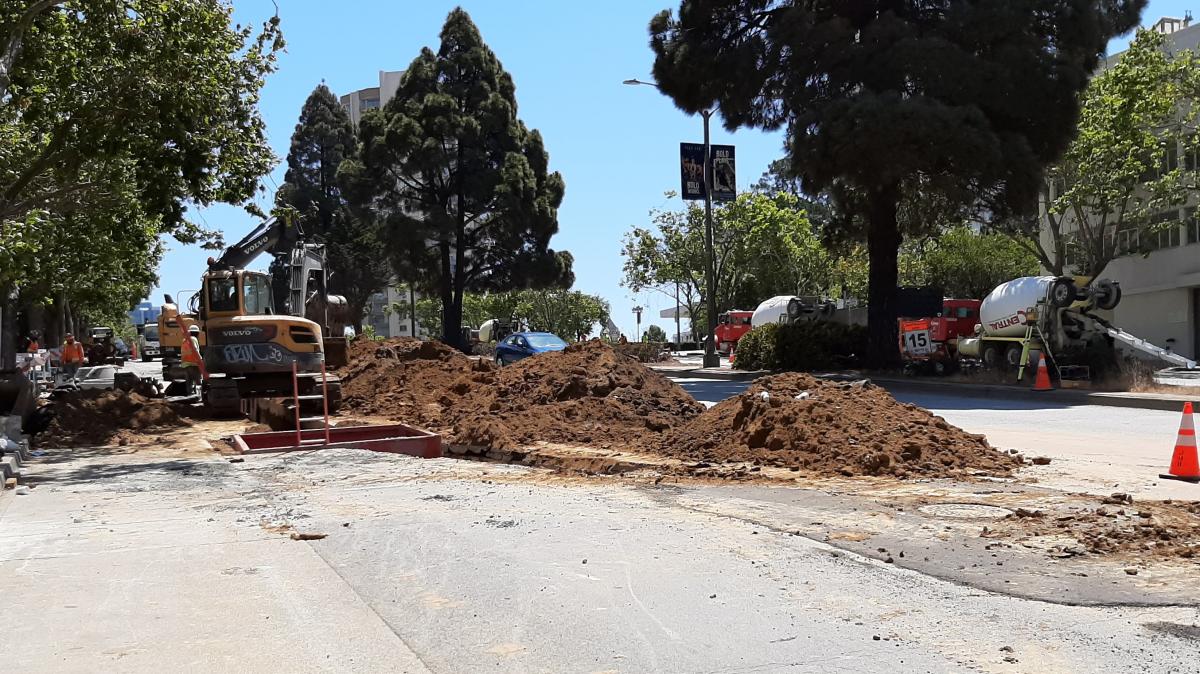 Crews installing a new sewer manhole and restoring roadway pavement on Geary between Laguna and Cleary streets