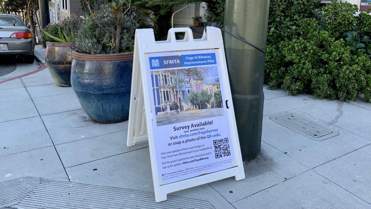 Image of an A-frame poster on Haight Street promoting the survey