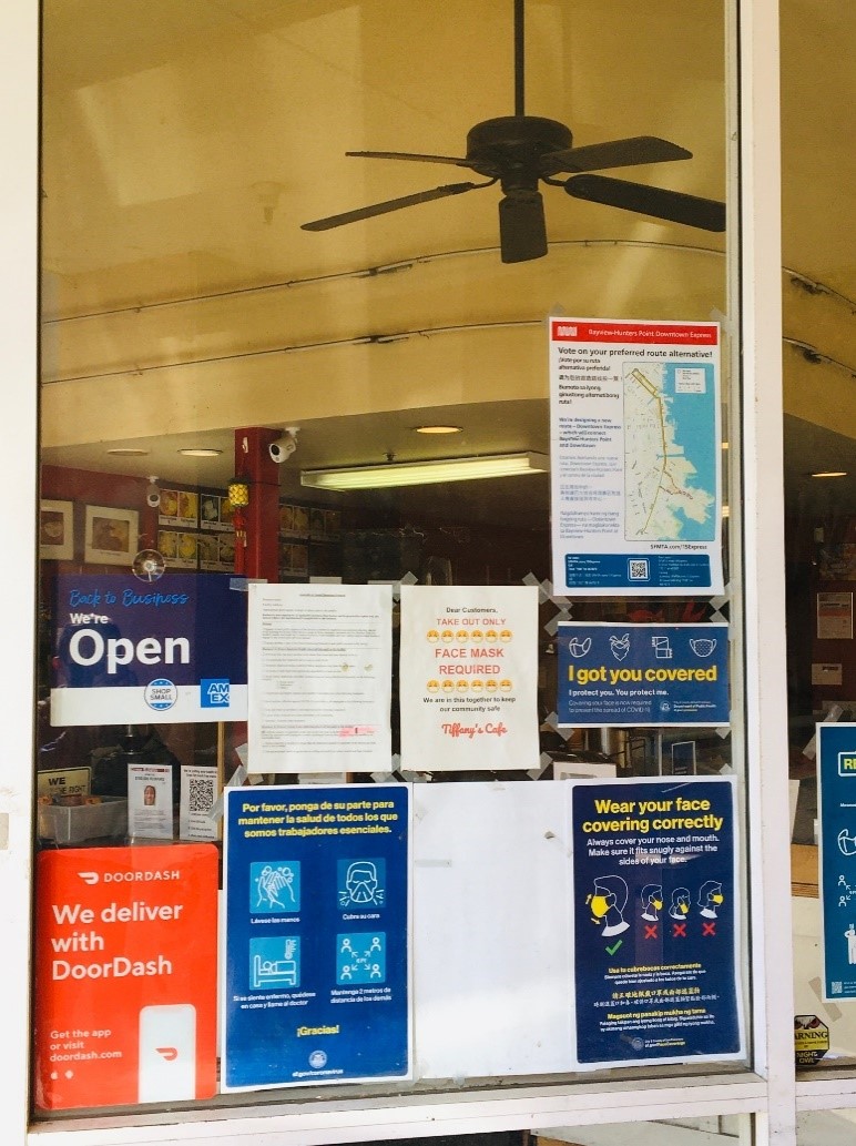 Photo of a storefront window, displaying the Bayview-Hunters Point Downtown Express Survey poster