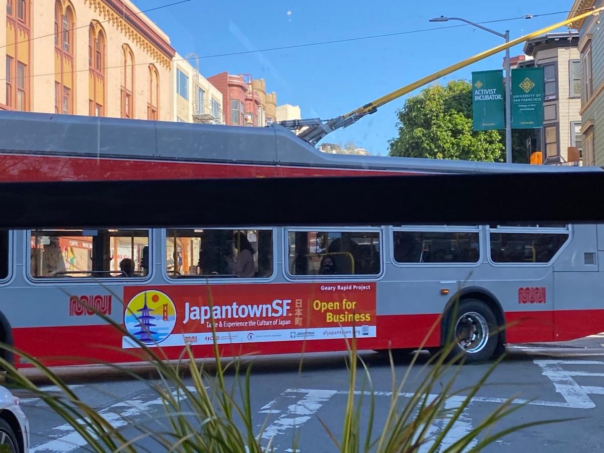 Muni Bus with sign advertising Japantown Open for Business