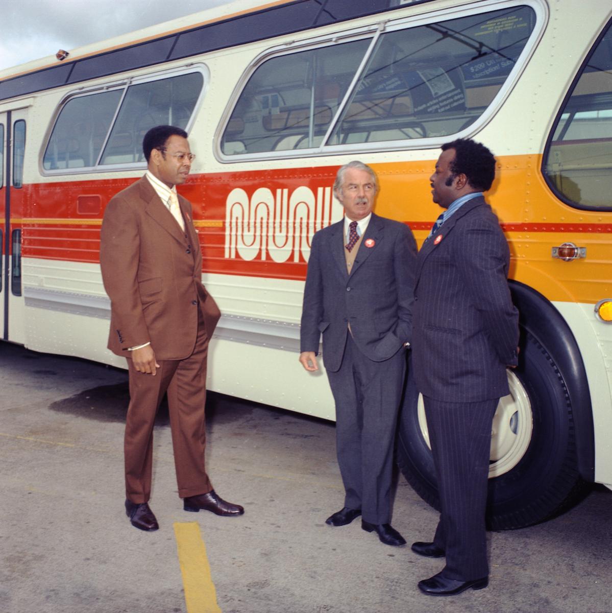 Welton Flynn, Curtis Green, and Walter Landor next to Muni Bus
