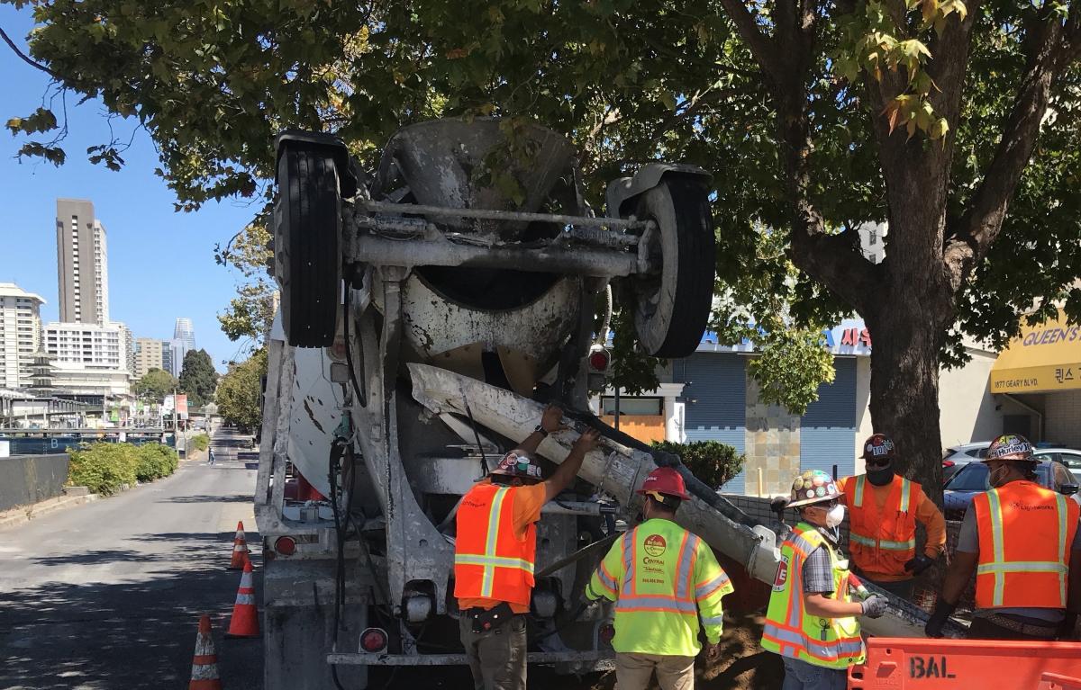 Photo: Crews pour concrete for the foundation of a new streetlight pole at Geary and Steiner