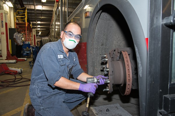 Potrero maintenance staff replacing a bus tire.